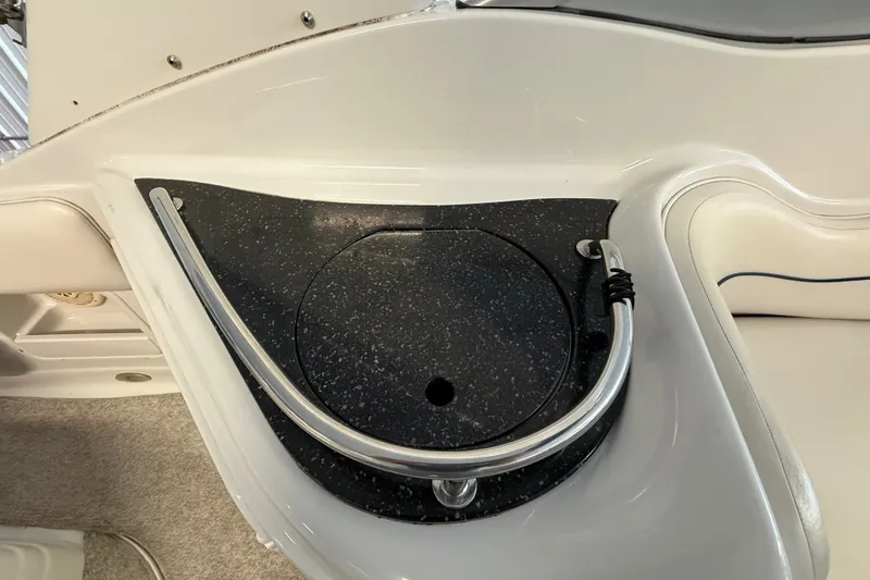 Slide: The Image of 2005 Crownline 270 CR boat interior detail with black countertop and stainless steel rail. - 13
