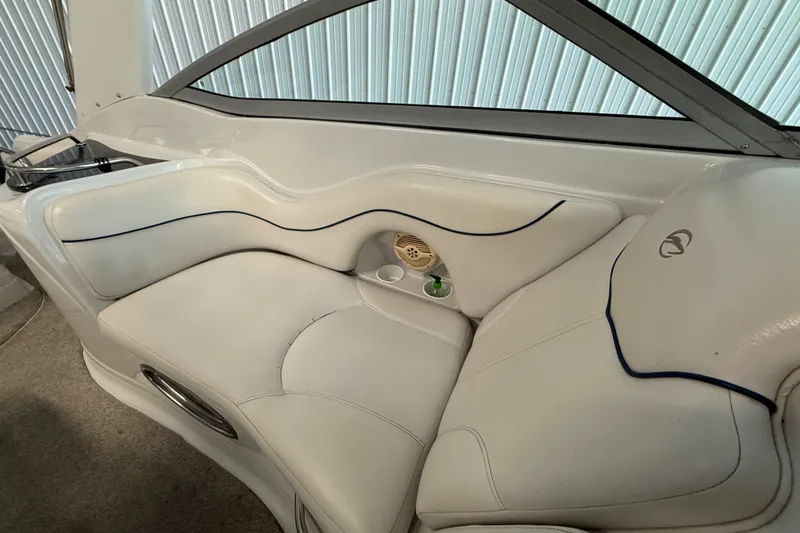 Slide: The Image of Luxurious white seating in a 2005 Crownline 270 CR boat interior. - 27