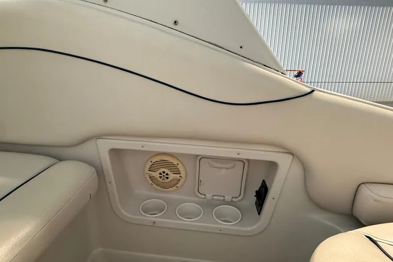 Slide: The Image of Interior of 2005 Crownline 270 CR boat showing speaker and cup holders. - 18