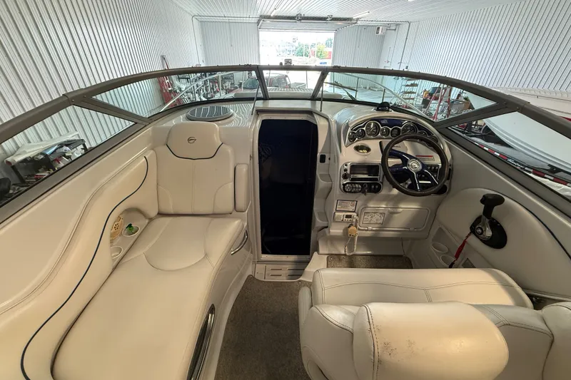 Slide: The Image of Interior of a 2005 Crownline 270 CR boat with white seating and control panel. - 19