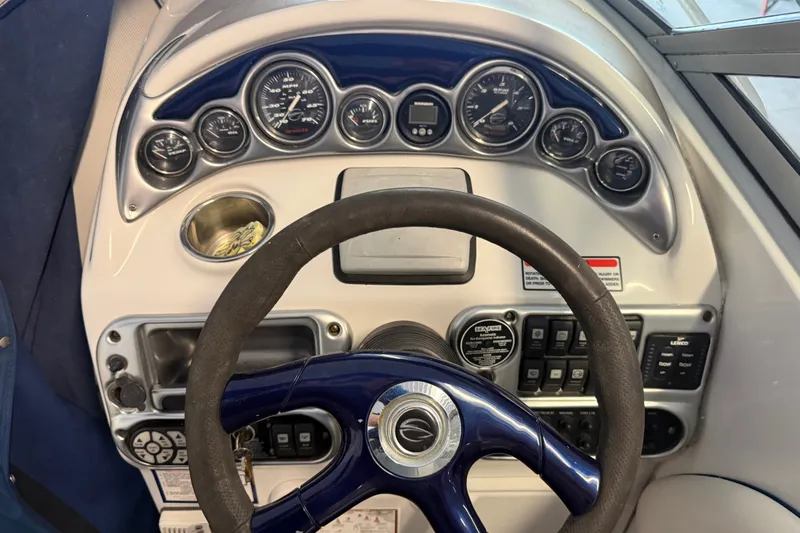 Slide: The Image of Dashboard of a 2005 Crownline 270 CR boat with gauges and steering wheel. - 20