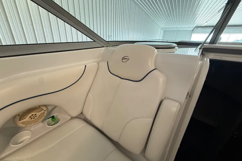 Slide: The Image of Interior of a 2005 Crownline 270 CR boat, featuring white seating and speaker. - 24