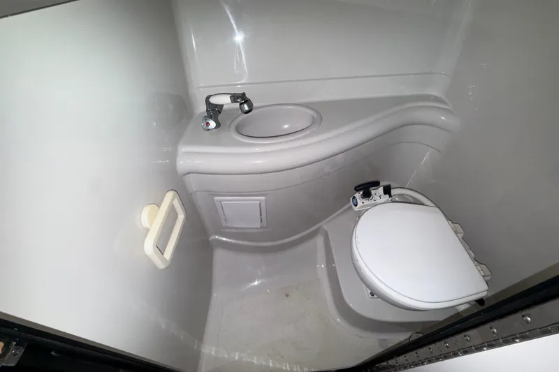 Slide: The Image of Compact bathroom in 2005 Crownline 270 CR boat with toilet and sink. - 45