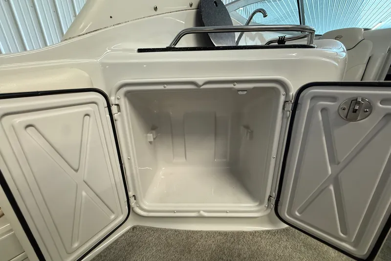 Slide: The Image of Open storage compartment on a 2005 Crownline 270 CR boat. - 15