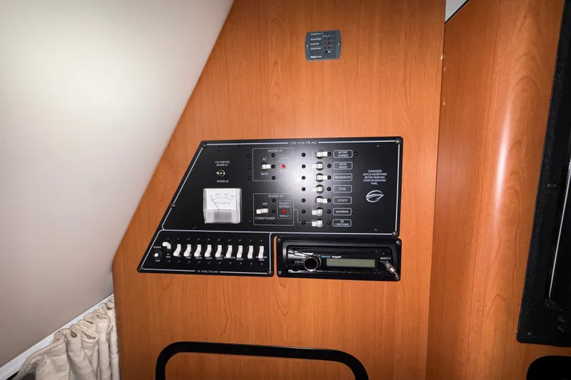 Slide: The Image of Control panel of a 2005 Crownline 270 CR boat with switches and a Sony stereo. - 49