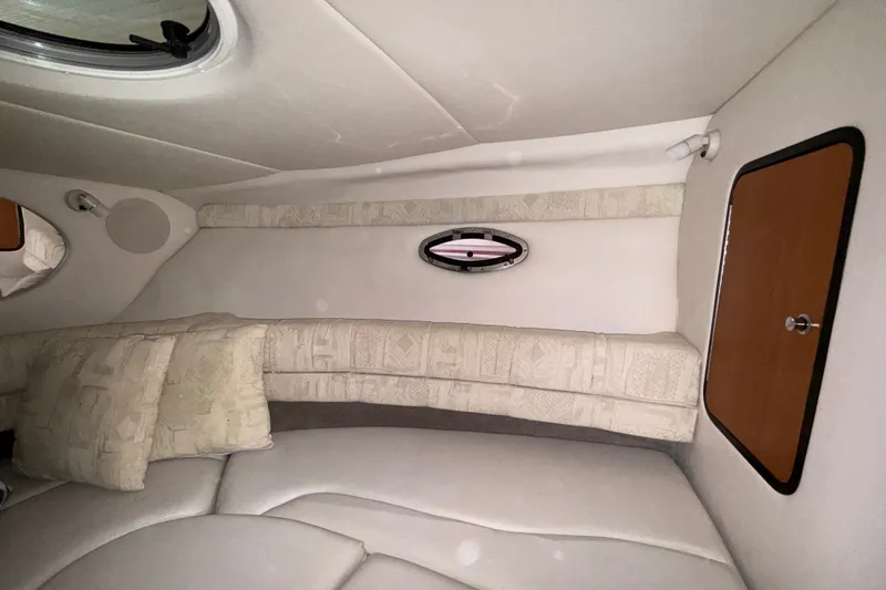 Slide: The Image of Interior cabin of 2005 Crownline 270 CR boat with cushions and porthole. - 33
