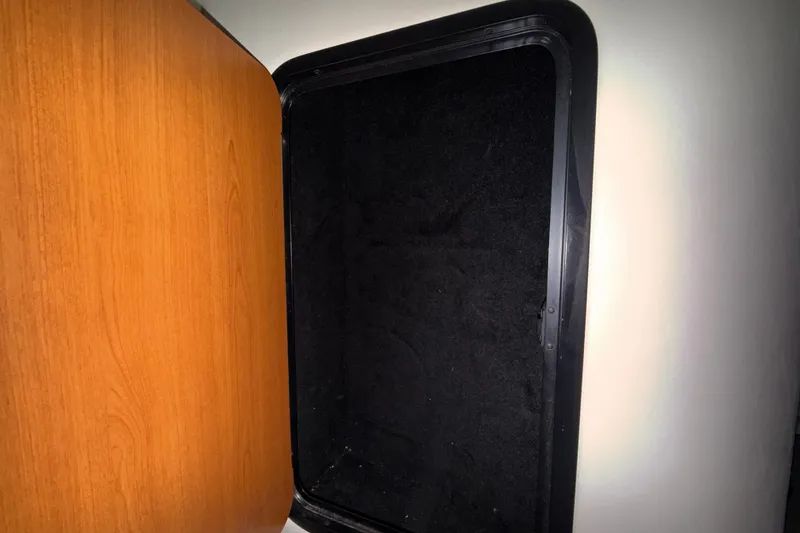 Slide: The Image of Open storage compartment in 2005 Crownline 270 CR boat interior. - 36