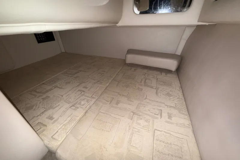 Slide: The Image of Interior cabin of a 2005 Crownline 270 CR boat, featuring patterned flooring. - 50