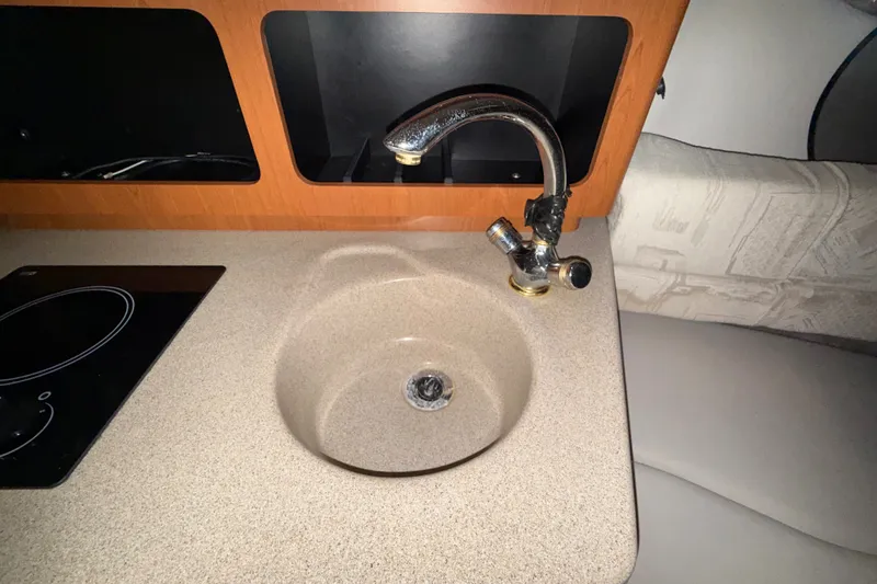 Slide: The Image of 2005 Crownline 270 CR boat interior with sink and countertop. - 42
