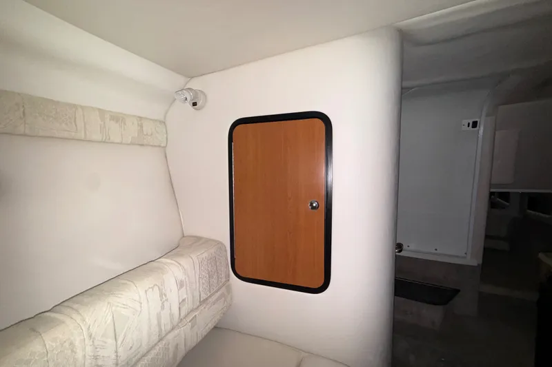 Slide: The Image of Interior of 2005 Crownline 270 CR boat with seating and wooden cabinet door. - 35