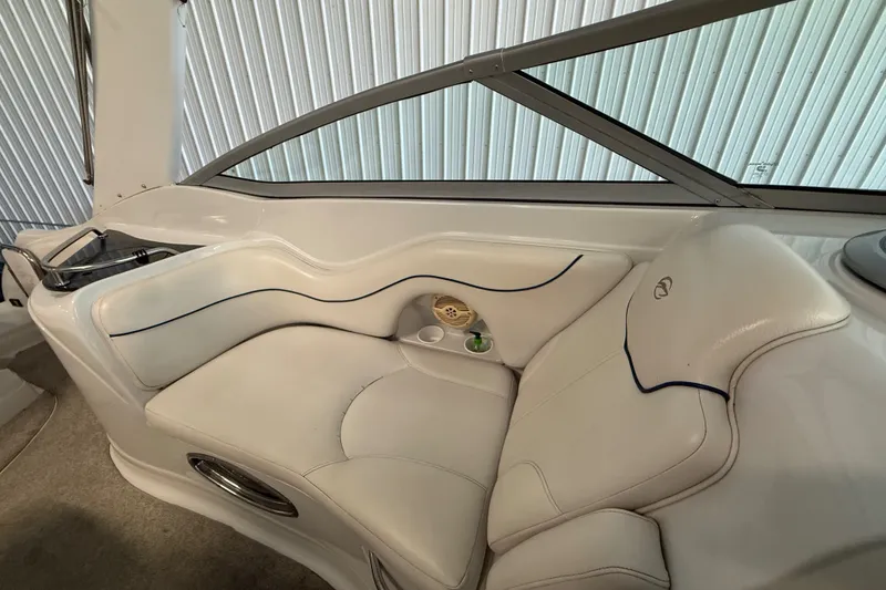 Slide: The Image of 2005 Crownline 270 CR boat interior with white leather seating and cup holder. - 25