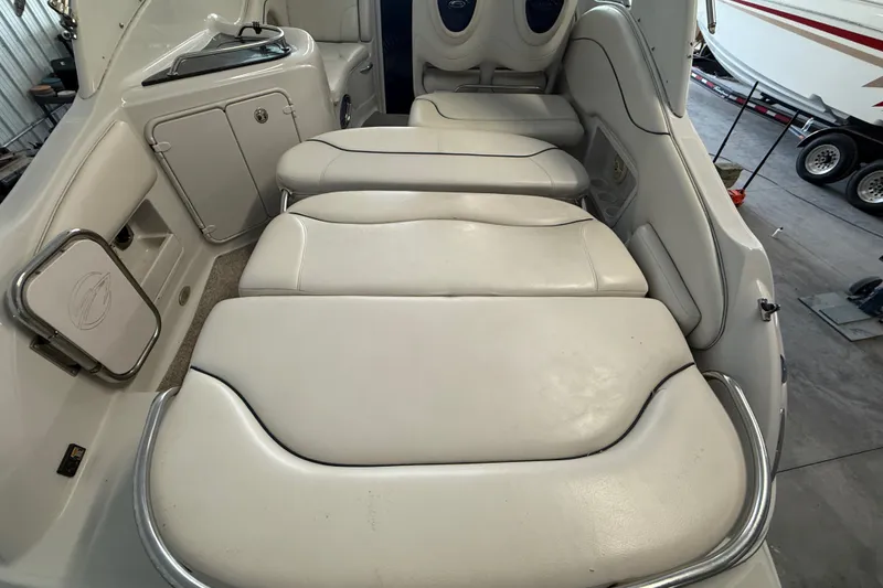 Slide: The Image of Interior seating of a 2005 Crownline 270 CR boat, featuring white cushioned seats. - 29
