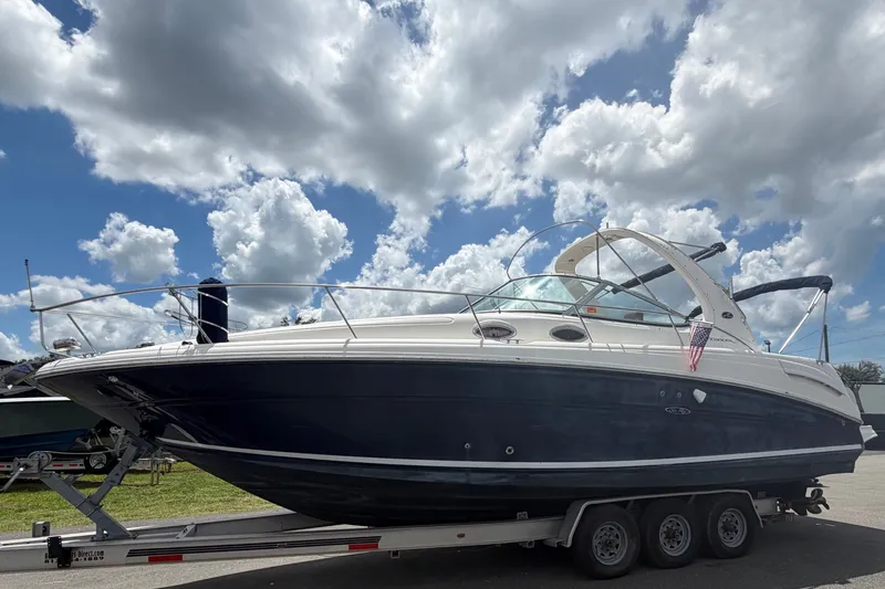 Slide: The Image of 2006 Sea Ray 300 Sundancer boat on trailer under cloudy sky. - 5