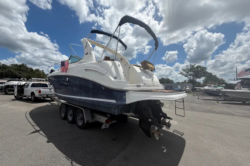 Slide: The Image of 2006 Sea Ray 300 Sundancer boat on trailer under cloudy sky. - 2