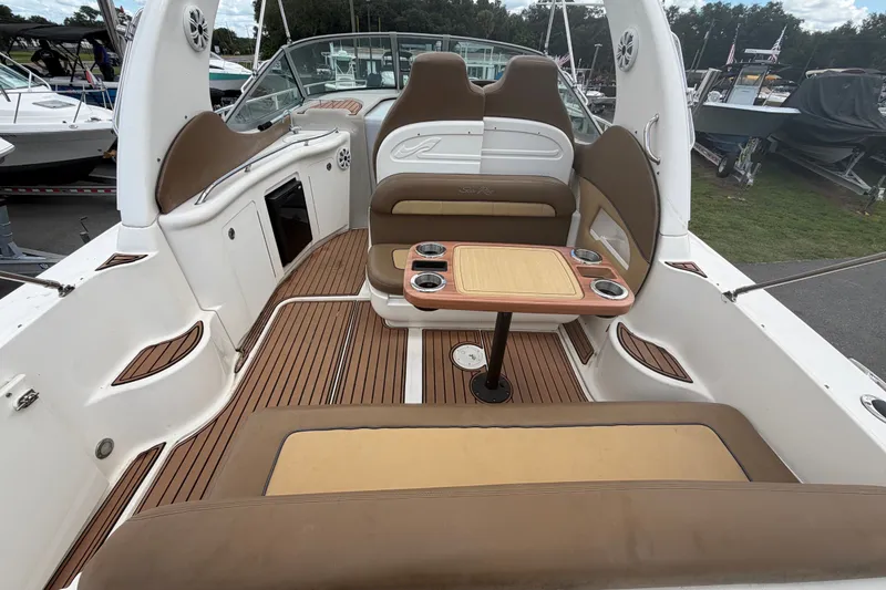 Slide: The Image of 2006 Sea Ray 300 Sundancer interior with seating and table, showcasing luxury boat design. - 10