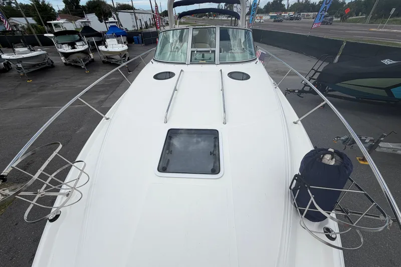 Slide: The Image of 2006 Sea Ray 300 Sundancer boat deck view at a marina. - 20