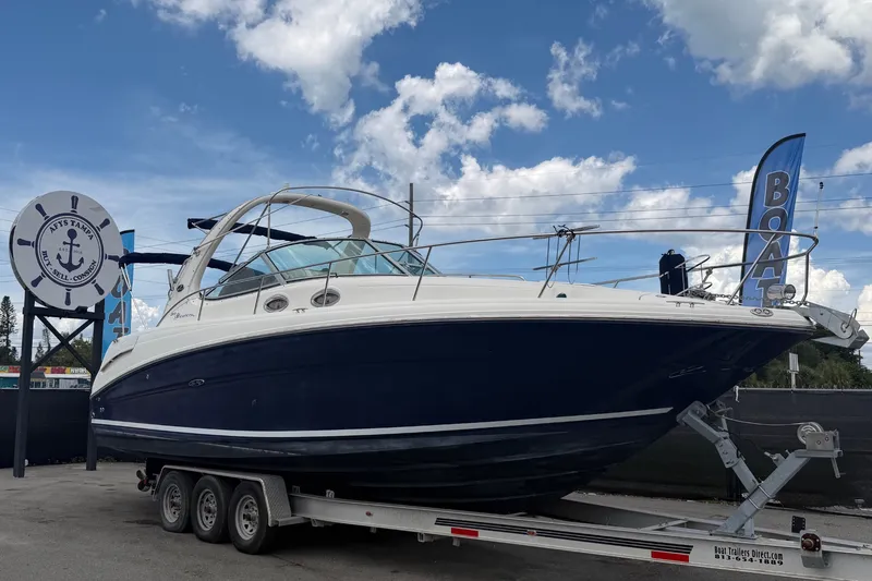 The Image of 2006 Sea Ray 300 Sundancer boat on trailer under blue sky. - 0