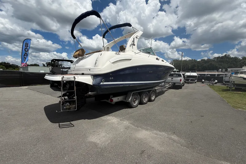 Slide: The Image of 2006 Sea Ray 300 Sundancer boat on trailer under cloudy sky. - 4