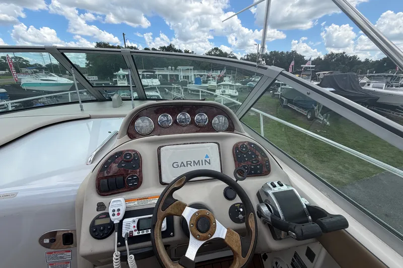 Slide: The Image of Helm of 2006 Sea Ray 300 Sundancer with Garmin navigation, showcasing controls and gauges. - 14