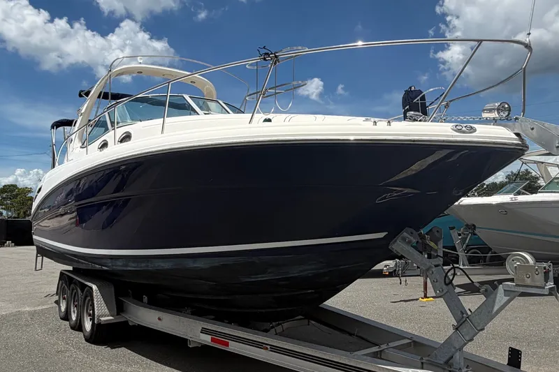 Slide: The Image of 2006 Sea Ray 300 Sundancer boat on trailer under a partly cloudy sky. - 6