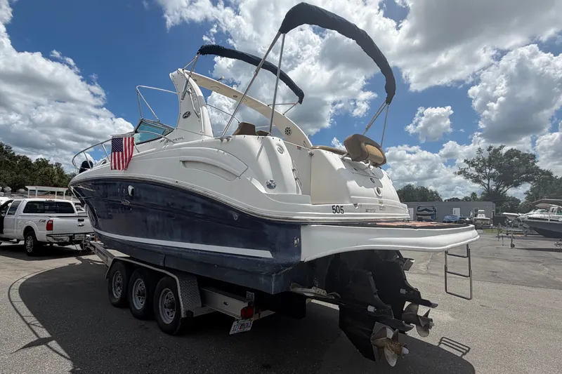 Slide: The Image of 2006 Sea Ray 300 Sundancer boat on trailer under cloudy sky. - 4