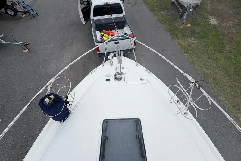 Slide: The Image of Top view of a 2006 Sea Ray 300 Sundancer boat near a parked truck. - 19