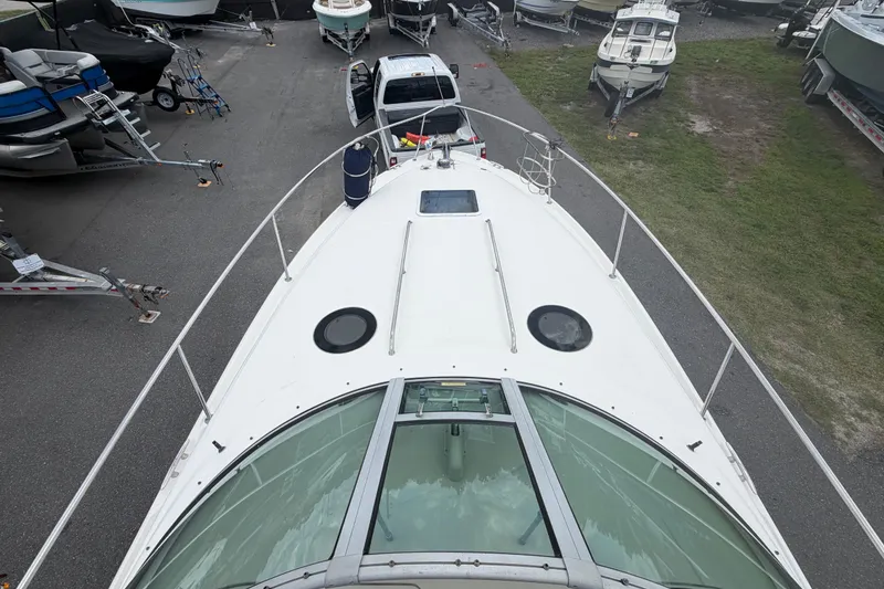 Slide: The Image of 2006 Sea Ray 300 Sundancer boat docked, viewed from above, surrounded by other boats. - 17