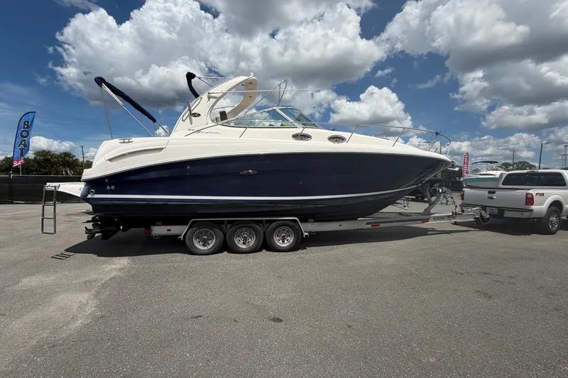 Slide: The Image of 2006 Sea Ray 300 Sundancer boat on trailer under cloudy sky. - 5