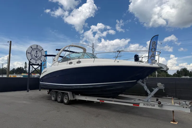 The Image of 2006 Sea Ray 300 Sundancer boat on trailer under blue sky. - 0
