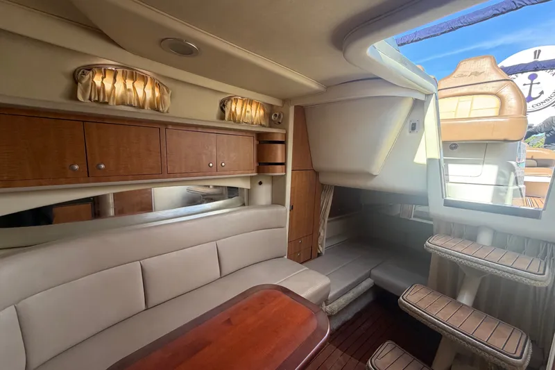 Slide: The Image of Interior of 2006 Sea Ray 300 Sundancer yacht with seating and wooden cabinetry. - 23
