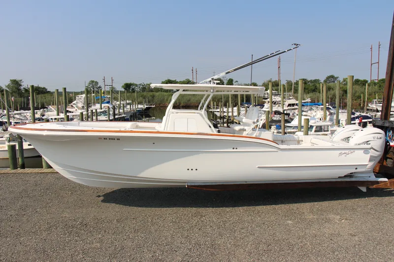 Slide: The Image of 2019 Buddy Davis 34 Center Console boat docked at a marina. - 22