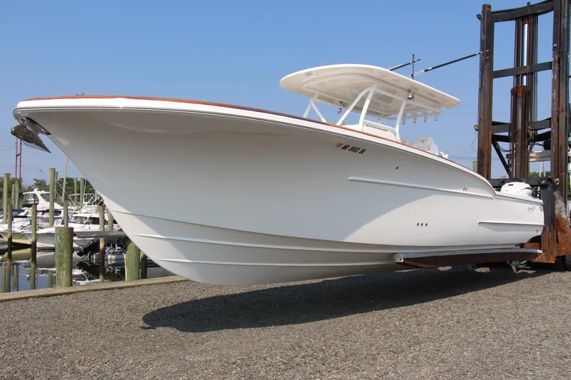 Slide: The Image of 2019 Buddy Davis 34 Center Console boat on dry dock, showcasing sleek design and craftsmanship. - 20