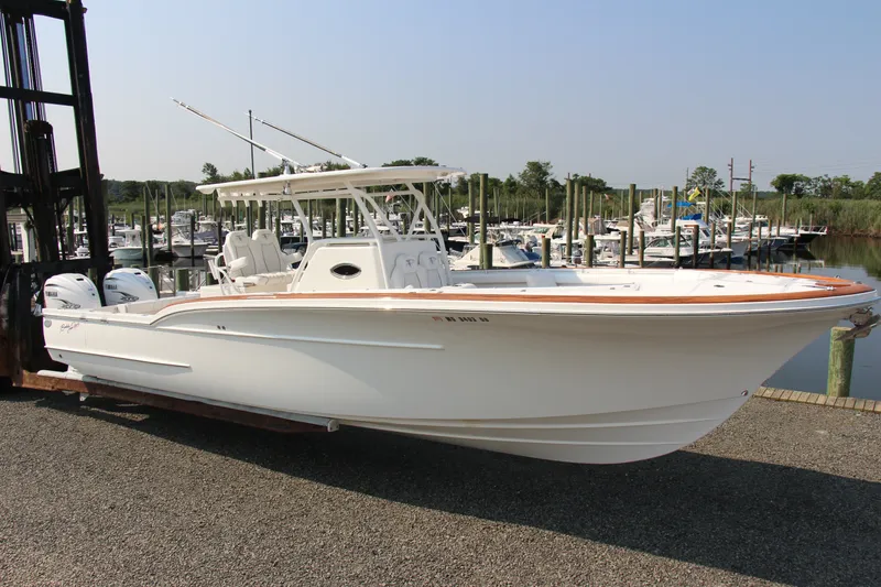 Slide: The Image of 2019 Buddy Davis 34 Center Console boat docked at marina. - 15
