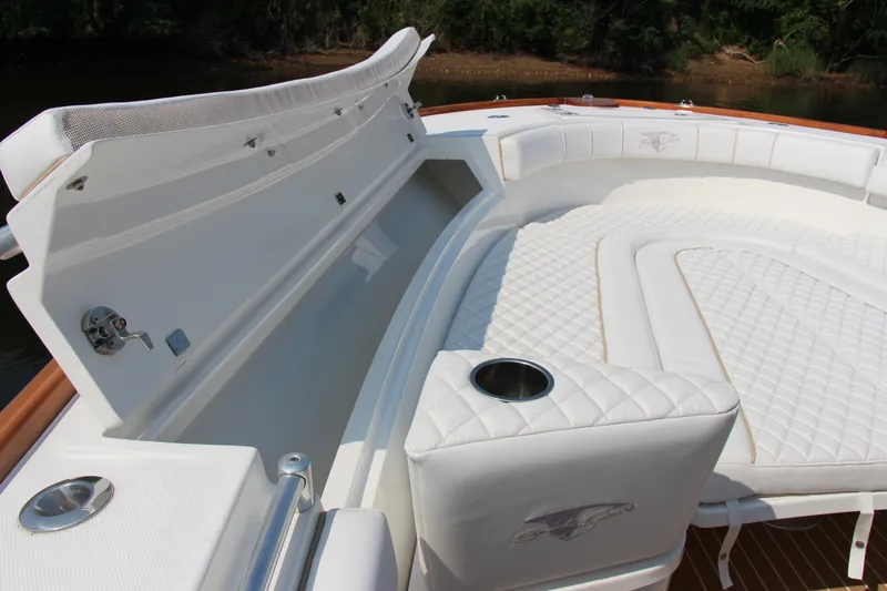 Slide: The Image of 2019 Buddy Davis 34 Center Console boat with luxurious white seating and storage compartments. - 30