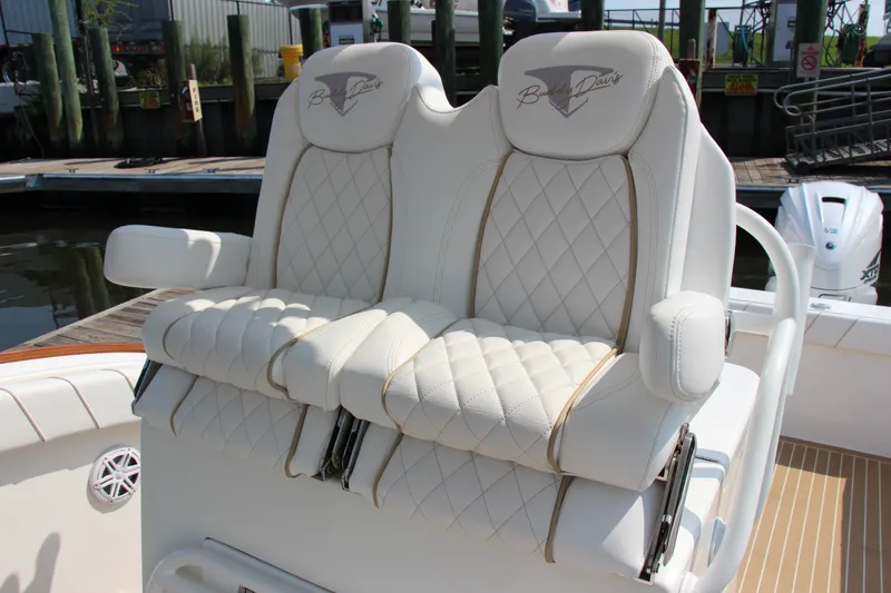 Slide: The Image of Luxurious seating on a 2019 Buddy Davis 34 Center Console boat, featuring quilted white upholstery. - 33