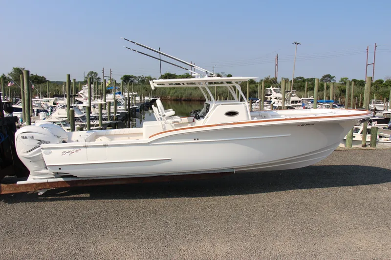Slide: The Image of 2019 Buddy Davis 34 Center Console boat docked at a marina. - 13