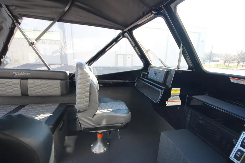 Slide: The Image of 2025 Weldcraft 210 Revolution Soft Top interior with modern seating and dashboard. - 16