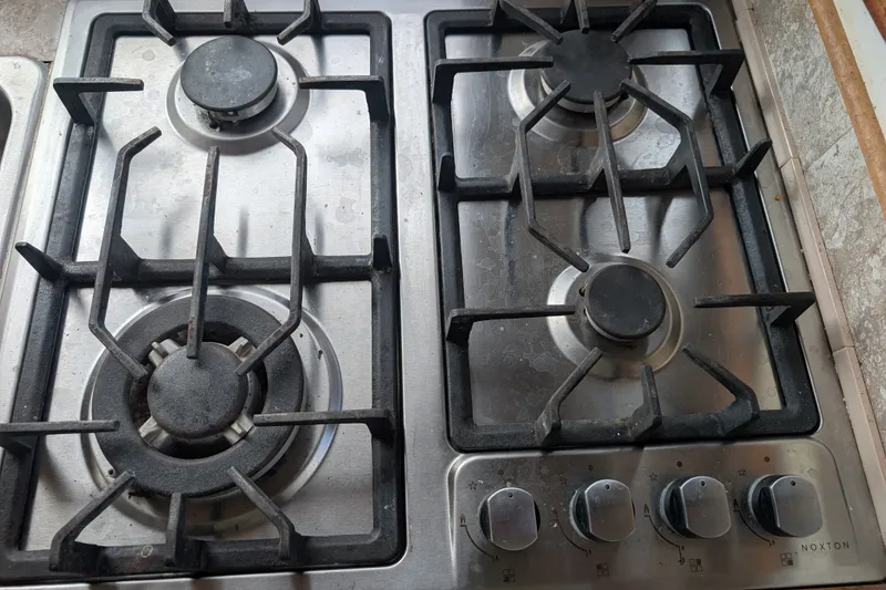 Slide: The Image of Stainless steel gas stove with four burners and control knobs, SUNYONG PS Trawler 1979 model. - 25