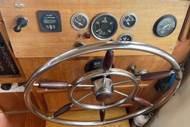Slide: The Image of 1979 SUNYONG PS Trawler helm with gauges and wooden steering wheel. - 31