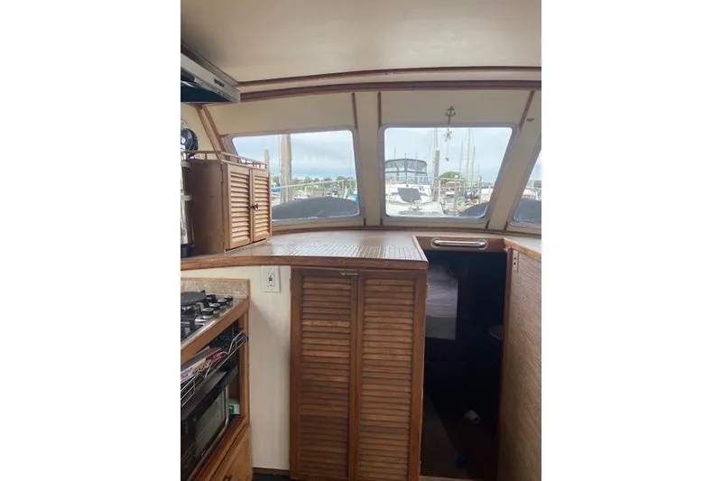 Slide: The Image of Interior of 1979 SUNYONG PS Trawler with wooden cabinetry and large windows. - 29