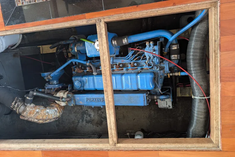 Slide: The Image of Engine compartment of a 1979 SUNYONG PS Trawler with a blue Perkins engine. - 52