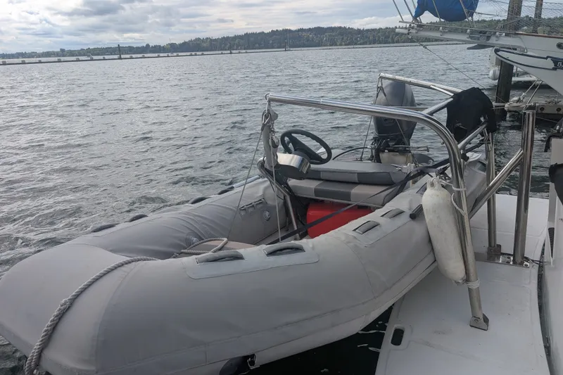 Slide: The Image of Inflatable boat docked beside a 1979 SUNYONG PS Trawler on a cloudy day. - 9