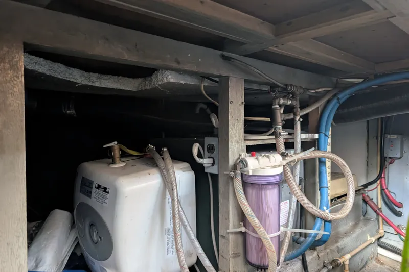 Slide: The Image of Engine room of a 1979 SUNYONG PS Trawler with visible plumbing and filtration system. - 55