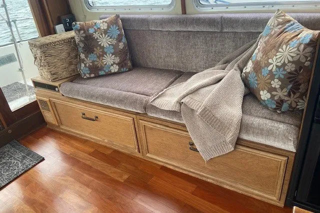 Slide: The Image of Cozy seating area on a 1979 SUNYONG PS Trawler with cushions and a blanket. - 19