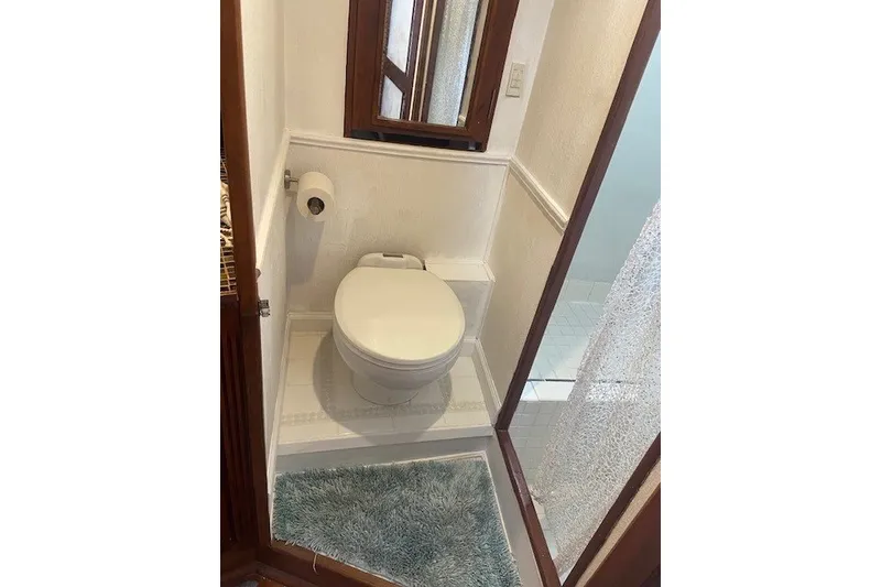 Slide: The Image of Small bathroom on 1979 SUNYONG PS Trawler with toilet, mirror, and shower. - 45