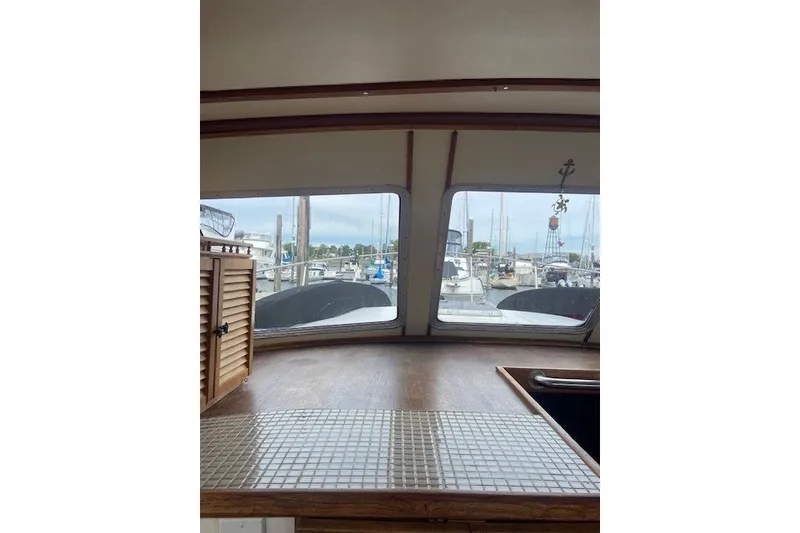 Slide: The Image of Interior view of 1979 SUNYONG PS Trawler with marina backdrop. - 28