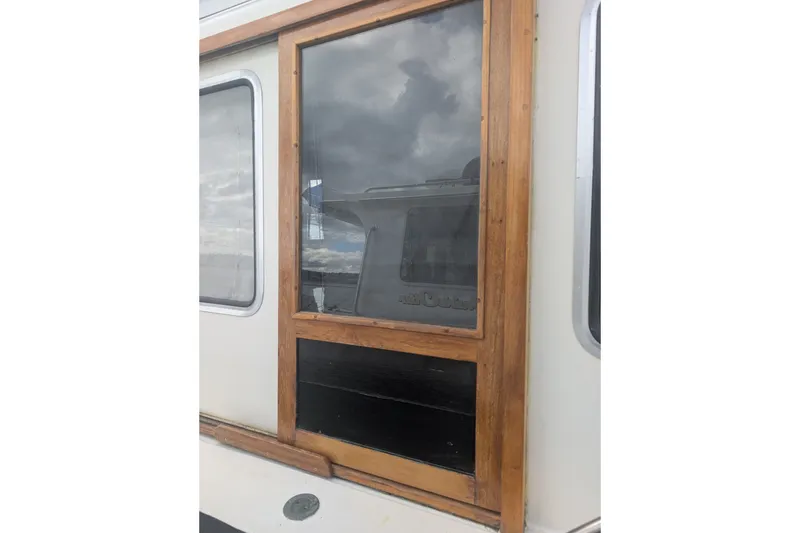 Slide: The Image of Wood-framed window on a 1979 SUNYONG PS Trawler boat exterior. - 49
