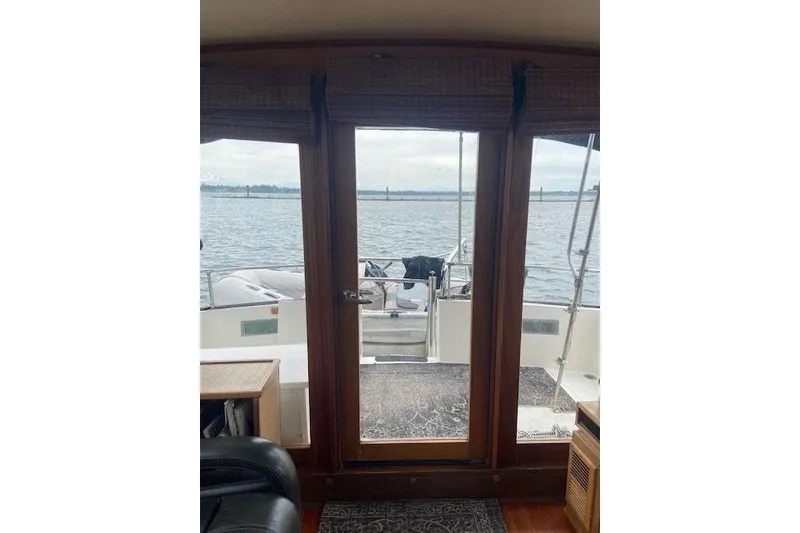 Slide: The Image of Interior view from a 1979 SUNYONG PS Trawler, overlooking the water through glass doors. - 30