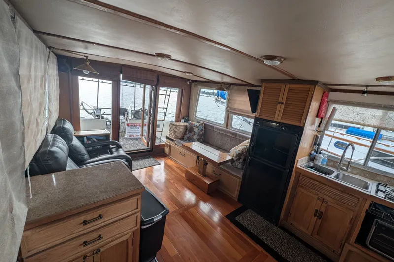 Slide: The Image of Interior of 1979 SUNYONG PS Trawler with cozy seating and kitchen area. - 16