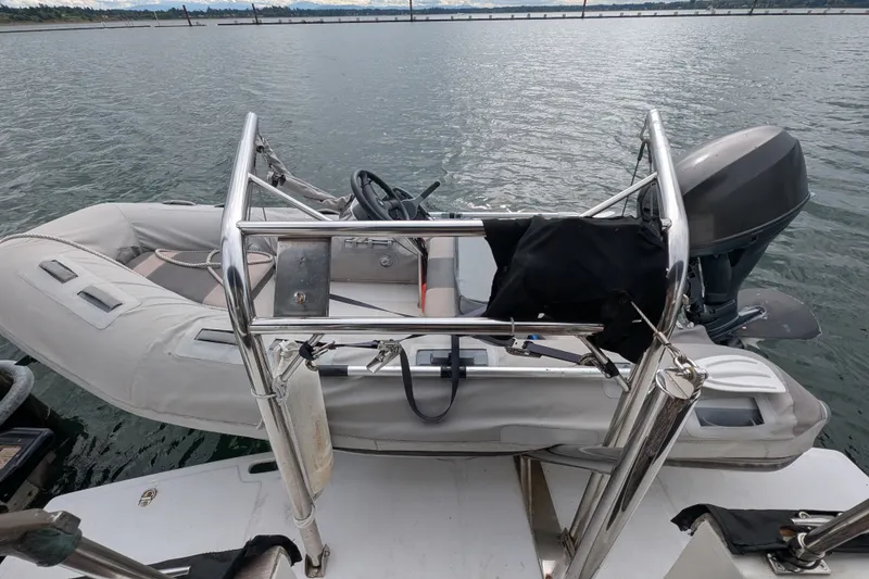 Slide: The Image of Inflatable boat with motor on SUNYONG PS Trawler, 1979, docked on calm water. - 8